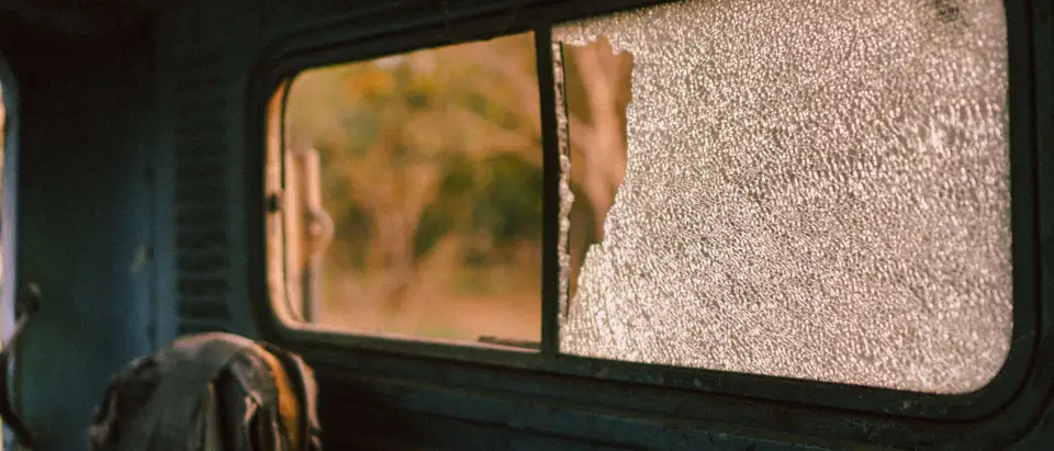 A shattered side window in a vehicle door