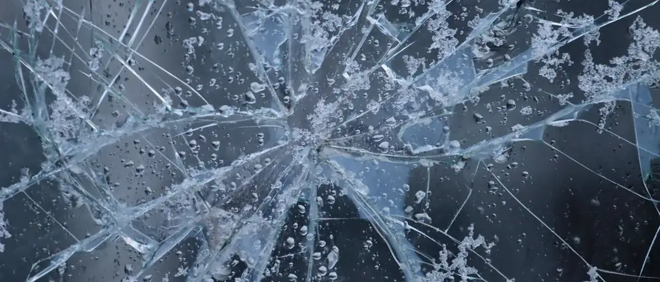 Cracks running out from an impact point in a pane of glass