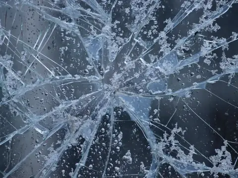 Cracks running out from an impact point in a pane of glass